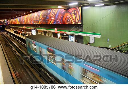 Stock Photograph - Chile, Santiago, Providencia, Metro Station, Parque Bustamante, subway, public transportation, rapid transit, train, mural, artist Alejandro Mono Gonzalez, Vida y Trabajo, Life and Work, passenger, rail, moving train, arriving, platform,. Fotosearch