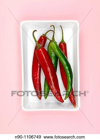 Chilli Peppers isolated on a pink background View Large Photo Image Stock Photo - Chilli Peppers isolated on a pink background. Fotosearch