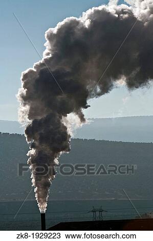 Stock Image - Chimney expelling pollutant gases to the air, Spain. Fotosearch
