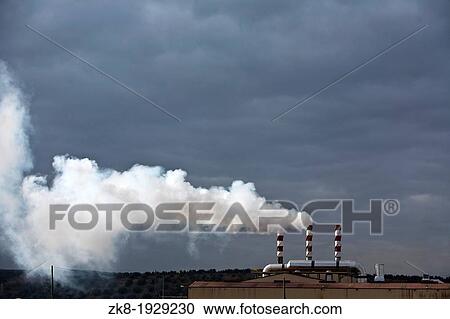 Stock Image - Chimney expelling pollutant gases to the air, Spain. Fotosearch