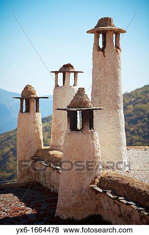 Chimneys on top of a building in Alpujarras de la Sierra, Spain, near the Sierra Nevada National Park View Large Photo Image Stock Photo - Chimneys on top of a building in Alpujarras de la Sierra, Spain, near the Sierra Nevada National Park. Fotosearch