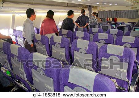 China, Beijing, Beijing Capital International Airport, PEK, arriving Air China flight from Shanghai, Asian, man, passenger, traveler, disembarking, empty seats, View Large Photo Image Stock Photo - China, Beijing, Beijing Capital International Airport, PEK, arriving Air China flight from Shanghai, Asian, man, passenger, traveler, disembarking, empty seats,. Fotosearch