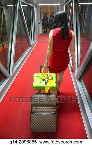 China, Beijing, Beijing Capital International Airport, PEK, arriving passenger, Asian, woman, suitcase, carry-on, luggage, rolling, red dress, carpet,. View Large Photo Image Stock Photography - China, Beijing, Beijing Capital International Airport, PEK, arriving passenger, Asian, woman, suitcase, carry-on, luggage, rolling, red dress, carpet,.. Fotosearch