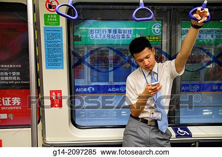 China, Beijing, Beijing Capital International Airport, PEK, Terminal 3, inside, interior, concourse, free shuttle train, gate area, rider, passenger, Asian, man, smartphone, checking messages, texting, Chinese characters h? nz? pinyin,. View Large Photo Image Stock Photography - China, Beijing, Beijing Capital International Airport, PEK, Terminal 3, inside, interior, concourse, free shuttle train, gate area, rider, passenger, Asian, man, smartphone, checking messages, texting, Chinese characters h? nz? pinyin,.. Fotosearch