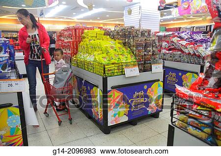 Stock Image - China, Beijing, Guang An Men Nei Da Jie, Guanganmen Outer Street, Rainbow Center, centre, shopping, supermarket, grocery store, sale, display, packaging, Chinese characters h? nz? pinyin, Asian, woman, mother, boy, son, cart,.. Fotosearch