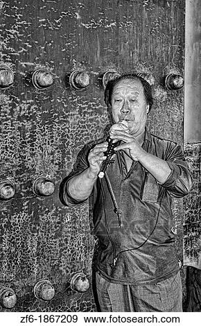 China Beijing Local man plays ancient flute for tourists in Beijing Forbidden City View Large Photo Image Stock Photo - China Beijing Local man plays ancient flute for tourists in Beijing Forbidden City. Fotosearch