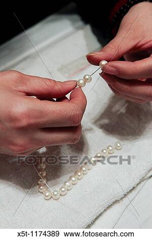 China, Beijing, woman working in a pearl factory showroom Stringing pearls View Large Photo Image Stock Photo - China, Beijing, woman working in a pearl factory showroom Stringing pearls. Fotosearch