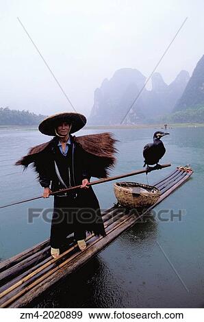 CHINA, GUANGXI PROVINCE, NEAR GUILIN, XING PING, LI RIVER, RAIN, FISHERMAN ON BAMBOO RAFT, CORMORANTS. View Large Photo Image Stock Photo - CHINA, GUANGXI PROVINCE, NEAR GUILIN, XING PING, LI RIVER, RAIN, FISHERMAN ON BAMBOO RAFT, CORMORANTS.. Fotosearch