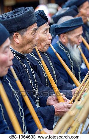 China, Guizhou province, Langde village, Long Skirt Miao people in traditional dress, mens are playing lusheng. View Large Photo Image Stock Image - China, Guizhou province, Langde village, Long Skirt Miao people in traditional dress, mens are playing lusheng.. Fotosearch
