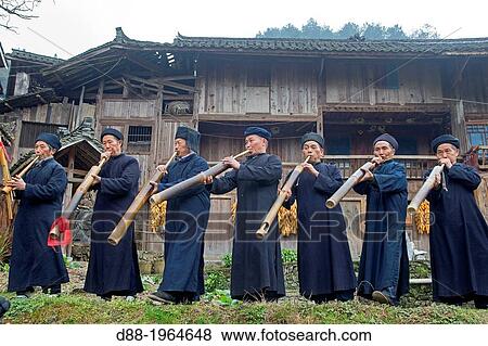 China, Guizhou province, Langde village, Long Skirt Miao people in traditional dress, mens are playing lusheng. View Large Photo Image Stock Photo - China, Guizhou province, Langde village, Long Skirt Miao people in traditional dress, mens are playing lusheng.. Fotosearch
