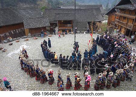 Stock Photo - China, Guizhou province, Langde village, Long Skirt Miao people in traditional dress, mens are playing lusheng,.. Fotosearch