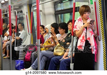 China, Hong Kong, Hong Kong MTR Subway, public transportation, Airport Express, onboard, train, cabin, passengers, riders, Asian, woman, looking, checking, smartphone, messages, texting,. View Large Photo Image Stock Image - China, Hong Kong, Hong Kong MTR Subway, public transportation, Airport Express, onboard, train, cabin, passengers, riders, Asian, woman, looking, checking, smartphone, messages, texting,.. Fotosearch
