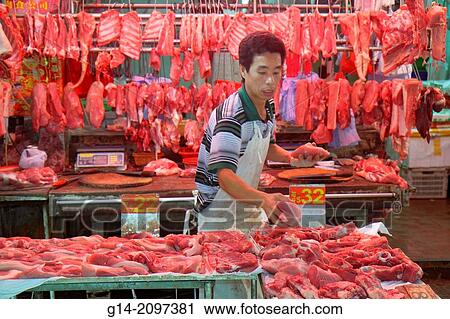 Stock Image - China, Hong Kong, Island, North Point, Marble Road Market, marketplace, sale, display, vendor, Asian, man, selling, butcher, meat,.. Fotosearch