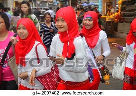 China, Hong Kong, Kowloon, Prince Edward, Tung Choi Street, Asian, teen, girl, Muslim, student, hijab, head covering, earbuds, smartphone,. View Large Photo Image Stock Image - China, Hong Kong, Kowloon, Prince Edward, Tung Choi Street, Asian, teen, girl, Muslim, student, hijab, head covering, earbuds, smartphone,.. Fotosearch