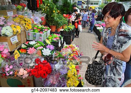 Stock Image - China, Hong Kong, Kowloon, Prince Edward, Flower Market Road, Mongkok, vendor, sale, display, shopping, buying, selling, Asian, woman, bouquets,.. Fotosearch