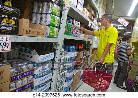 Stock Photography - China, Hong Kong, Kowloon, Sham Shui Po, shopping, grocery store, supermarket, sale, display, shelves, Asian, man, aisle, beer,.. Fotosearch