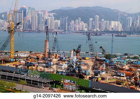 China, Hong Kong, Kowloon, Tsim Sha Tsui, New World Centre, center, construction site, cranes, economic development, Victoria Harbour, harbor, Island, city skyline, skyscrapers, high rise buildings,. View Large Photo Image Stock Photograph - China, Hong Kong, Kowloon, Tsim Sha Tsui, New World Centre, center, construction site, cranes, economic development, Victoria Harbour, harbor, Island, city skyline, skyscrapers, high rise buildings,.. Fotosearch