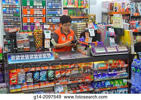 China, Hong Kong, New Territories, Sha Tin, Ma Liu Shui, University MTR Subway Station, public transportation, concession, 7-Eleven, convenience store, counter, employee, manager, cashier, Asian, woman, sale, display shelves,. View Large Photo Image Stock Photo - China, Hong Kong, New Territories, Sha Tin, Ma Liu Shui, University MTR Subway Station, public transportation, concession, 7-Eleven, convenience store, counter, employee, manager, cashier, Asian, woman, sale, display shelves,.. Fotosearch