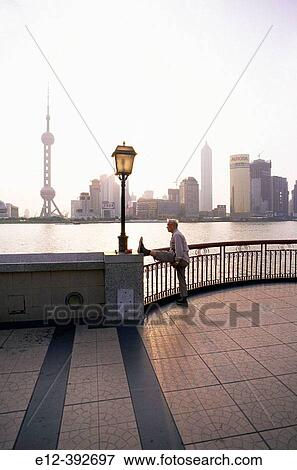 China. Shanghai. Elder training in the sunrise in front of Pudong. Business district skyline View Large Photo Image Stock Photo - China. Shanghai. Elder training in the sunrise in front of Pudong. Business district skyline. Fotosearch