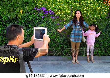 Picture - China, Shanghai, Huangpu District, The Bund, Zhongshan Road, Asian, woman, mother, man, father, girl, daughter, posing, tablet, iPad, National Day Golden Week, taking picture,. Fotosearch