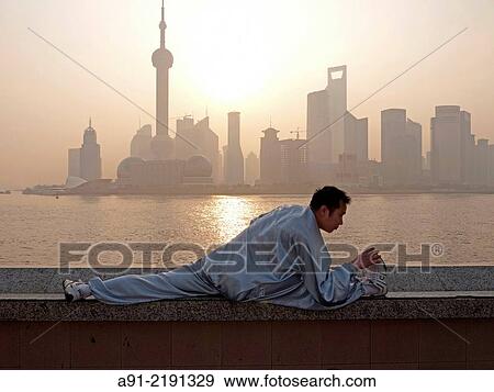 China, Shanghai, on the Bund along river HuangPu with new town of Pudong on other bank, early morning Tai Chi View Large Photo Image Stock Photo - China, Shanghai, on the Bund along river HuangPu with new town of Pudong on other bank, early morning Tai Chi. Fotosearch