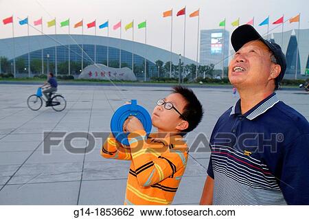 China, Shanghai, Pudong Xin District, Oriental Sports Center, Asian, man, senior, grandfather, boy, grandson, learning, teaching, kite flyer, flying, reel, line, hand wheel, hobby, View Large Photo Image Stock Image - China, Shanghai, Pudong Xin District, Oriental Sports Center, Asian, man, senior, grandfather, boy, grandson, learning, teaching, kite flyer, flying, reel, line, hand wheel, hobby,. Fotosearch
