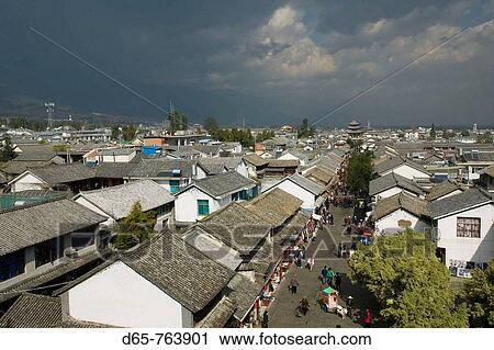 Stock Image - China. Yunnan Province. Dali: Dali Old Town. Pedestrian Zone on Wenxian Lu with Wuhua Building / Morning. Fotosearch