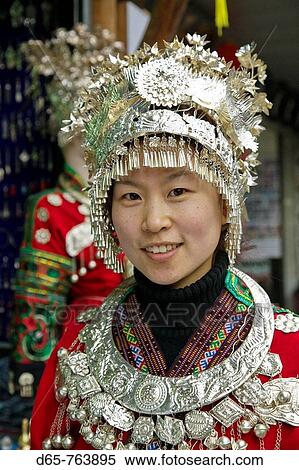 Stock Photography - China. Yunnan Province. Dali: Dali Old Town. Young Woman in Traditional Bai Minority Costume. Bai Minority People being the main ethnic group in the Dali Area.. Fotosearch