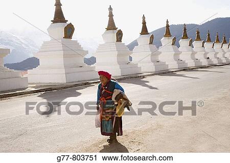 Stock Image - China Yunnan Shangri-La region Dequin, called Shangri-La Road from Zhongdian to Dequin, on the Tibetan Border Buddhist Stupa Naxi Woman. Fotosearch