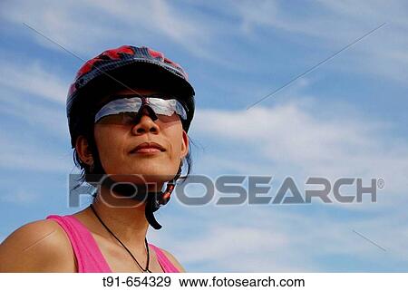 Chines girl is wearing classes and a bicycle helmet View Large Photo Image Stock Photo - Chines girl is wearing classes and a bicycle helmet. Fotosearch