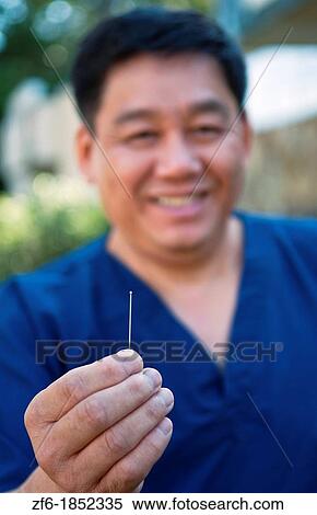 Chinese Acupuncture pain control doctor with single needle portrait View Large Photo Image Stock Photography - Chinese Acupuncture pain control doctor with single needle portrait. Fotosearch
