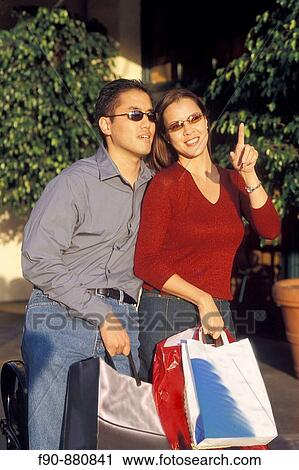Chinese American couple rests while shopping MR View Large Photo Image Stock Image - Chinese American couple rests while shopping MR. Fotosearch