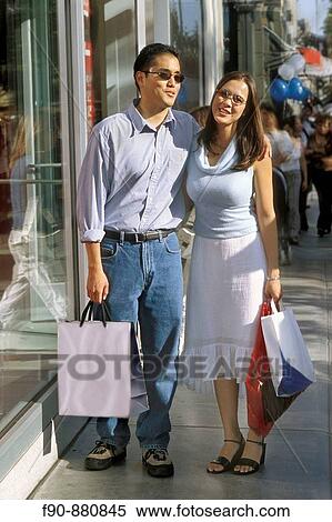 Chinese American couple shopping MR View Large Photo Image Stock Photography - Chinese American couple shopping MR. Fotosearch