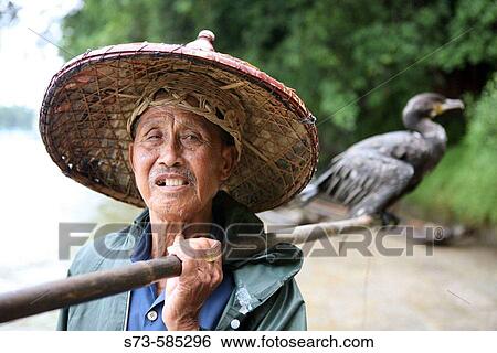 Stock Photograph - Chinese cormorant fisherman. Yangshuo. China.. Fotosearch