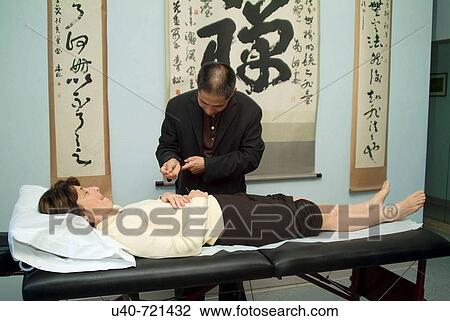 Chinese doctor performing acupuncture View Large Photo Image Stock Image - Chinese doctor performing acupuncture. Fotosearch