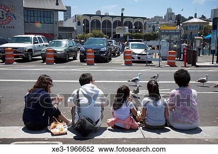 Stock Image - Chinese family eating on the street. Fisherman's Wharf, San Francisco.. Fotosearch