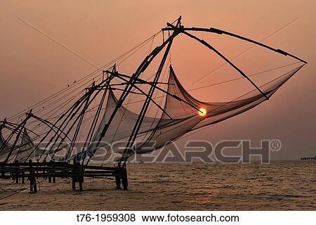 Chinese fish nets at sunset in Fort Cochin (Kochi) in Kerala, India. View Large Photo Image Stock Photo - Chinese fish nets at sunset in Fort Cochin (Kochi) in Kerala, India.. Fotosearch