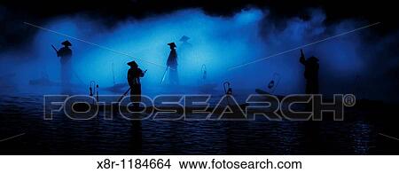 Chinese fishermen are silhouetted at night in the south province of Guangxi, China. View Large Photo Image Picture - Chinese fishermen are silhouetted at night in the south province of Guangxi, China.. Fotosearch