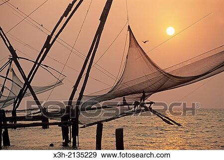 Chinese fishing nets at Kochi at sunset, State of Kerala, India, South Asia. View Large Photo Image Stock Photo - Chinese fishing nets at Kochi at sunset, State of Kerala, India, South Asia.. Fotosearch