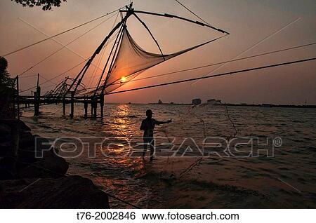 Stock Photograph - Chinese fishing nets at sunset in Fort Cochin (Kochi) in Kerala, India.. Fotosearch