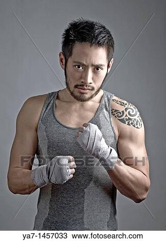 Stock Image - Chinese Kick Boxer with Tattoo. Fotosearch
