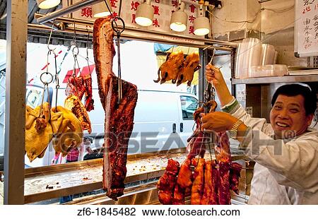 Chinese man arranging Peking Duck in window in Chinatown San Francisco California View Large Photo Image Stock Image - Chinese man arranging Peking Duck in window in Chinatown San Francisco California. Fotosearch