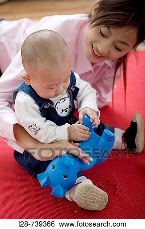 chinese mother play with baby at home View Large Photo Image Stock Photograph - chinese mother play with baby at home. Fotosearch