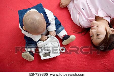 Stock Photography - chinese mother stay with baby at home. Fotosearch