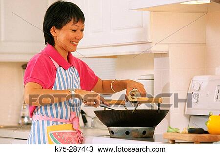 Chinese woman cooking Chinese food View Large Photo Image Stock Image - Chinese woman cooking Chinese food. Fotosearch