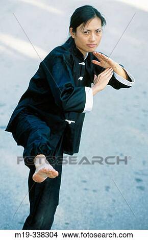 Chinese woman doing Tai Chi View Large Photo Image Picture - Chinese woman doing Tai Chi. Fotosearch