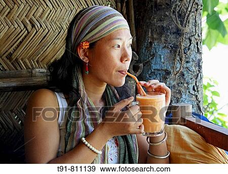 Stock Photo - Chinese woman drinking juice. Fotosearch