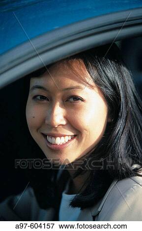 Chinese woman drives car View Large Photo Image Stock Photo - Chinese woman drives car. Fotosearch
