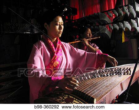 Chinese zither, musicians using traditional instruments to perform in Temple of Eternal Peace, Beihai Park (Beihai Gonggyuan). Beijing, China View Large Photo Image Stock Image - Chinese zither, musicians using traditional instruments to perform in Temple of Eternal Peace, Beihai Park (Beihai Gonggyuan). Beijing, China. Fotosearch