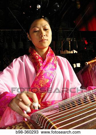 Chinese zither, musicians using traditional instruments to perform in Temple of Eternal Peace, Beihai Park (Beihai Gonggyuan). Beijing, China View Large Photo Image Stock Image - Chinese zither, musicians using traditional instruments to perform in Temple of Eternal Peace, Beihai Park (Beihai Gonggyuan). Beijing, China. Fotosearch